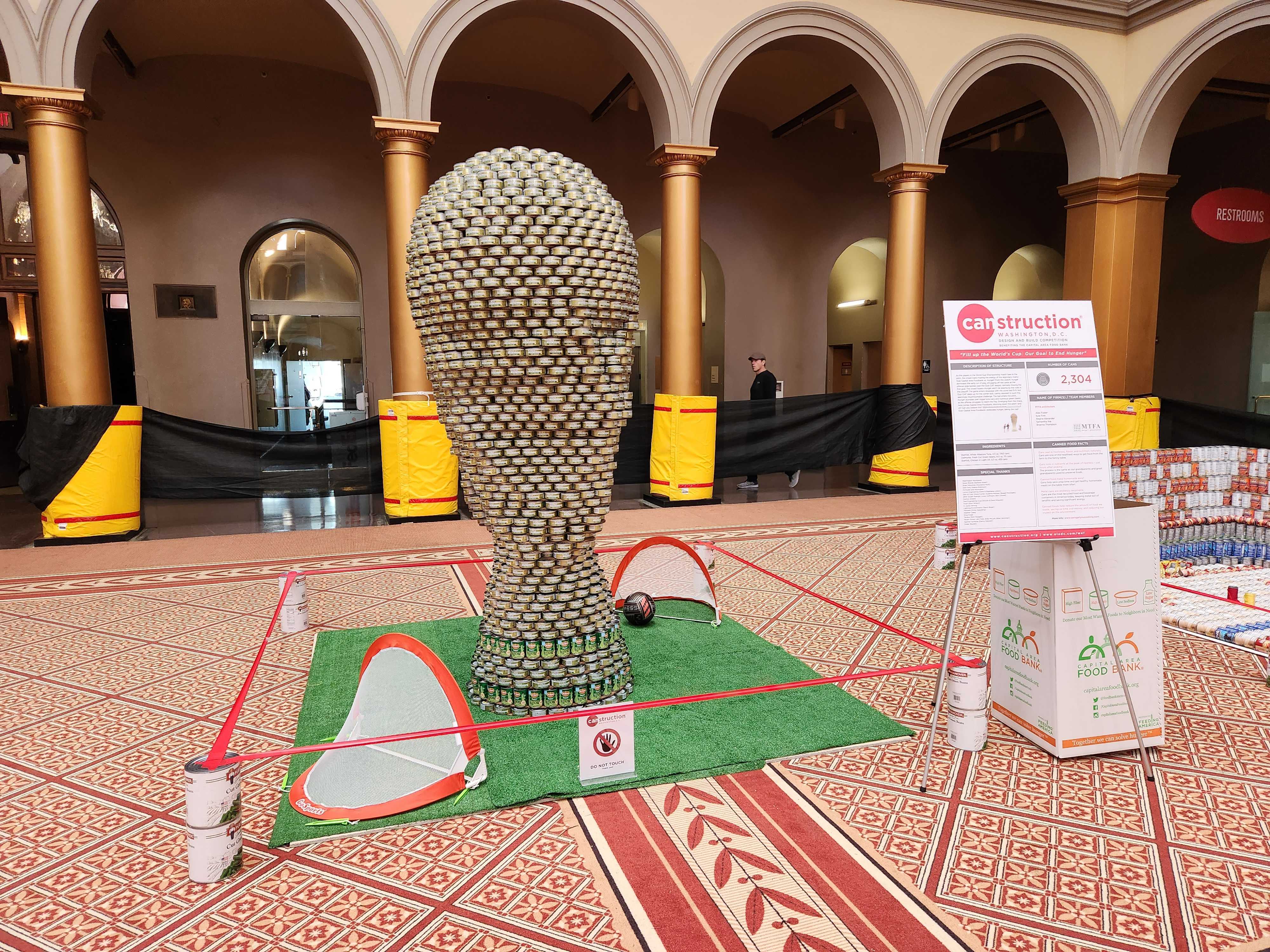 Image of canned food sculpture in shape of world cup trophy