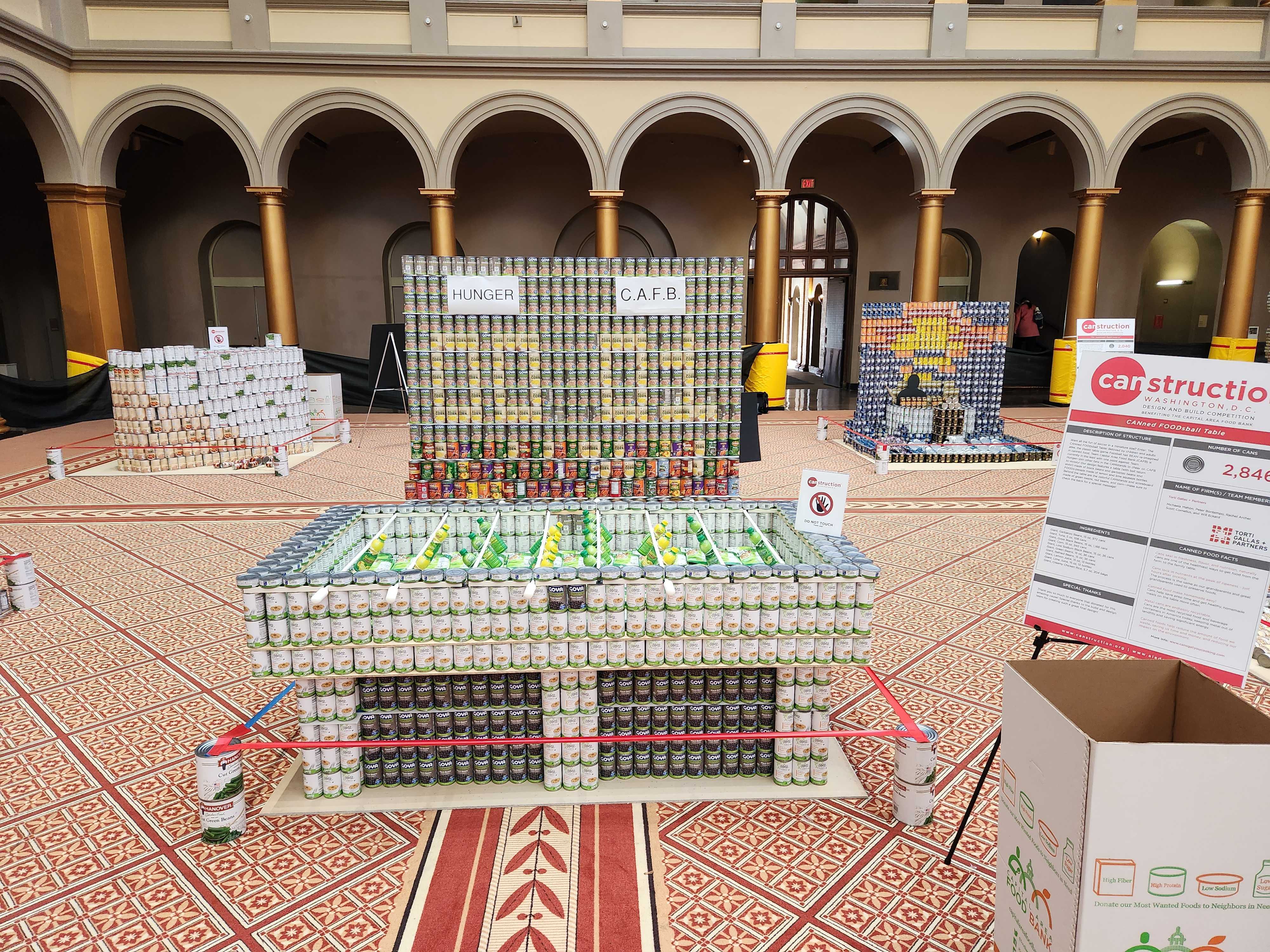 Image of canned food sculpture in shape of foosball table