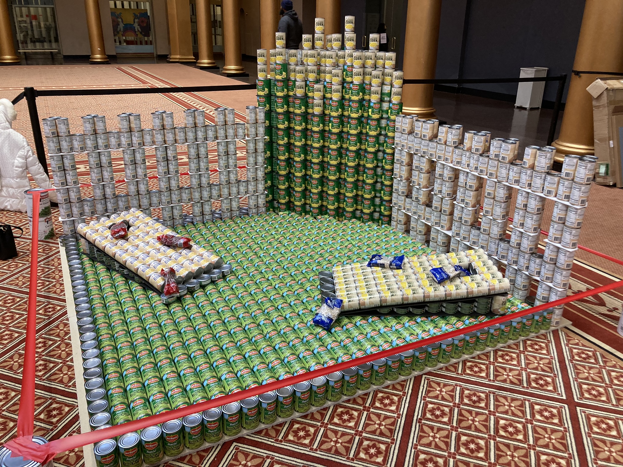 Image of canned food sculpture in shape of cornhole set
