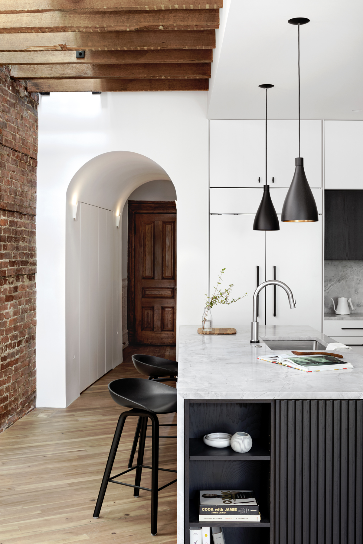 Modern kitchen with historic elements - view toward a sculpted kitchen entryway